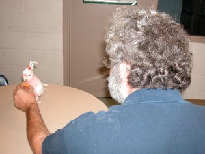 Steve Sharing his Lunch With Henry, a Major Mitchell's Cockatoo
